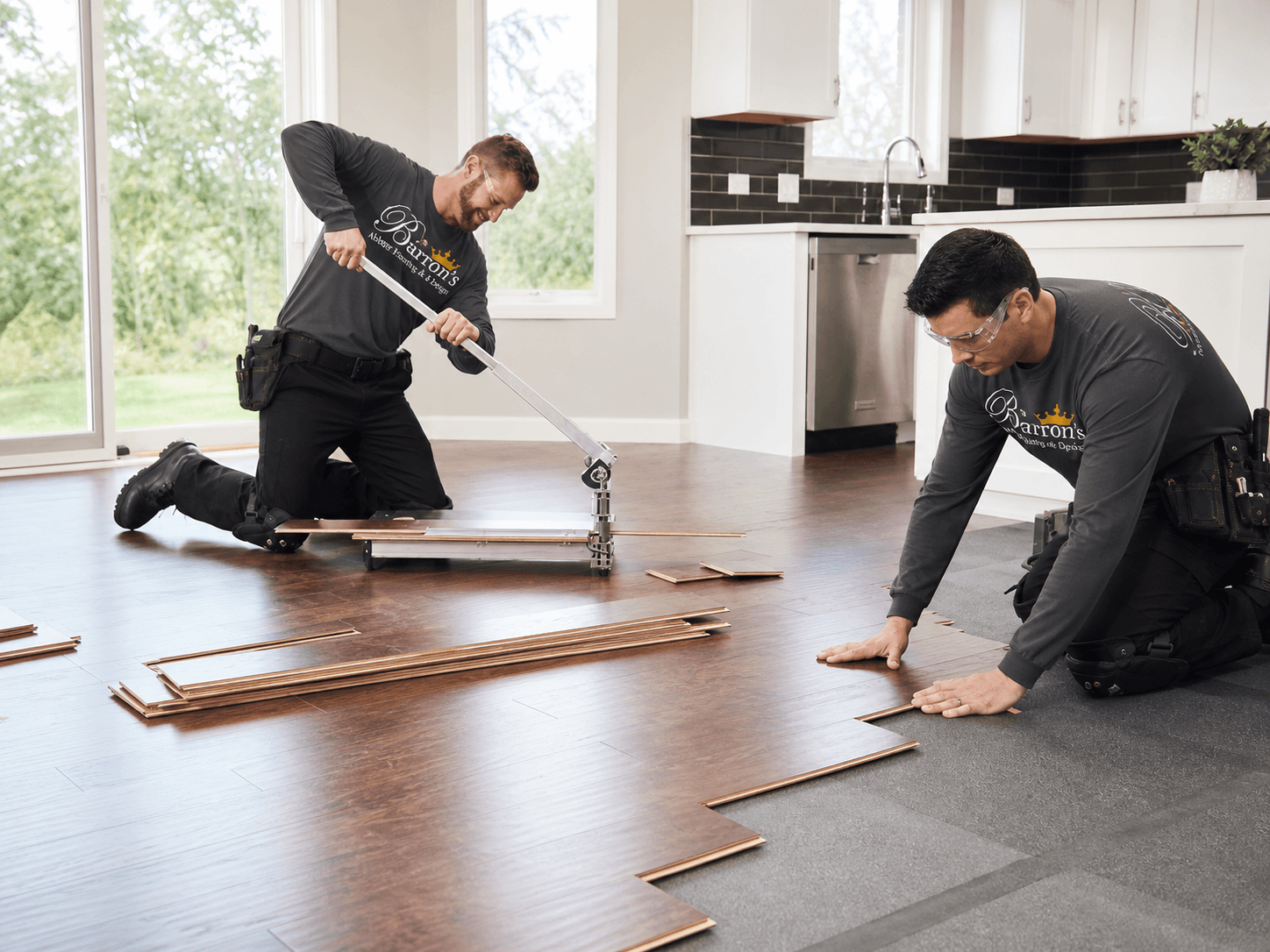 Barron's installers laying new hardwood flooring in a customer's home