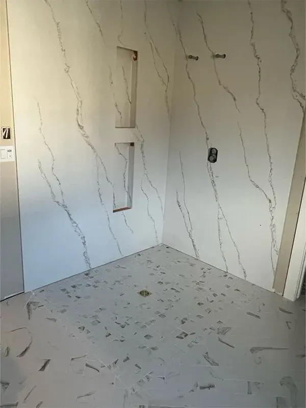 Bathroom project by Barron's Flooring & Home in Jackson, CA featuring Quartz slab with built-in niches, 2×2 mosaic porcelain tile, curbless pan, 12×24 porcelain tile