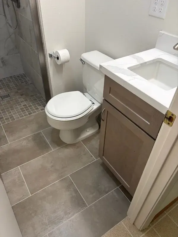 Bathroom project by Barron's Flooring & Home in Jackson, CA featuring Surface Art Touchstone 12×24 grey lappato tile, Surface Art Gallant 2×2 noce matte tile, Surface Art Touchstone 2×4 brick grey lappato tile