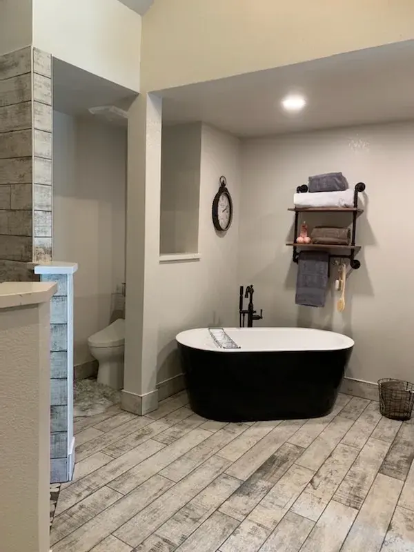 Bathroom project by Barron's Flooring & Home in Placerville, CA featuring Surface Art Oxidized Plank tile, Weathered Light, Maniscalco Botany Bay sliced pebble, Shadow Blend, Surface Art Oxidized Plank tile, Weathered Light