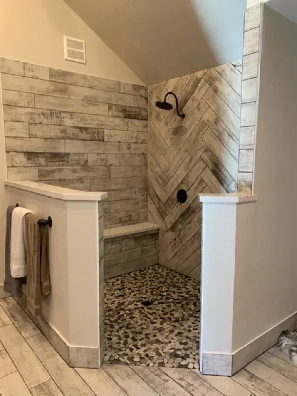 Bathroom project by Barron's Flooring & Home in Placerville, CA featuring Surface Art Oxidized Plank tile, Weathered Light, Maniscalco Botany Bay sliced pebble, Shadow Blend, Surface Art Oxidized Plank tile, Weathered Light
