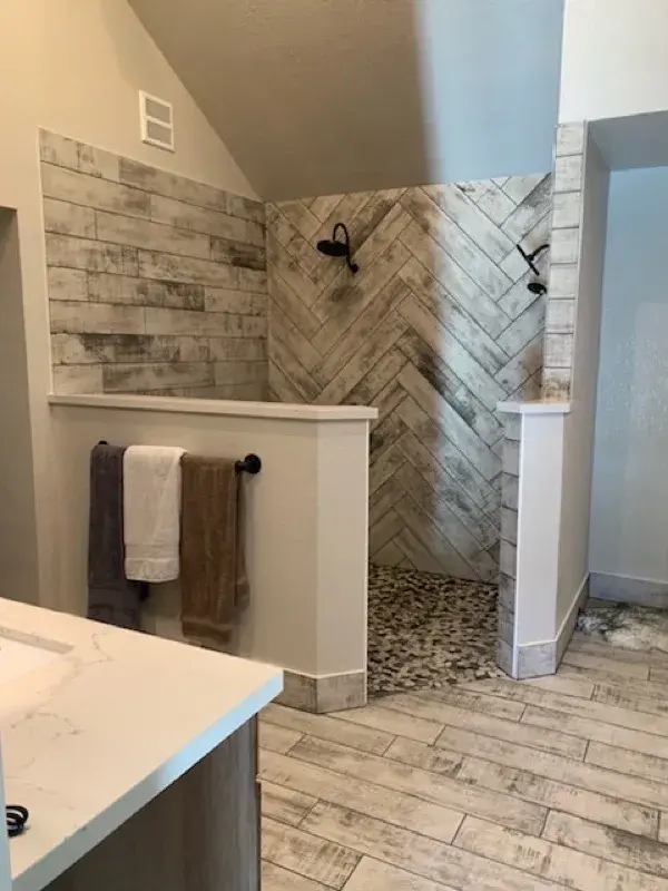 Bathroom project by Barron's Flooring & Home in Placerville, CA featuring Surface Art Oxidized Plank tile, Weathered Light, Maniscalco Botany Bay sliced pebble, Shadow Blend, Surface Art Oxidized Plank tile, Weathered Light
