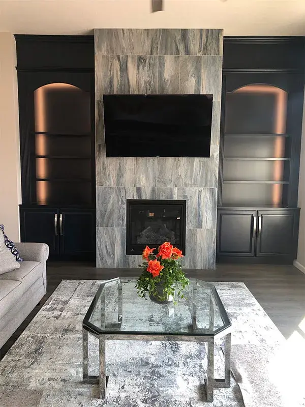 Fireplace project by Barron's Flooring & Home in Jackson, CA featuring 12×24 porcelain tile, Canyon Creek Maple painted built-ins, LED back lighting