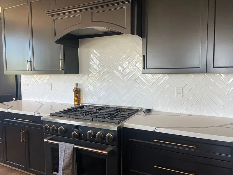 Kitchen project by Barron's Flooring & Home in Sutter Creek, CA featuring Canyon Creek Maple painted cabinets, MSI Calacatta Night quartz countertop, Surface Art Subway tile