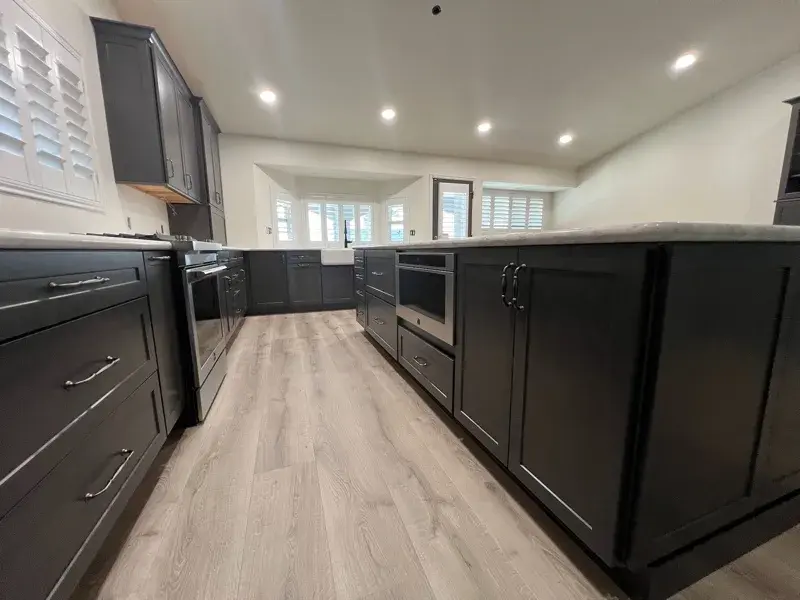 Kitchen project by Barron's Flooring & Home in Ione, CA featuring Kemper Maple cabinets, Marimac door, Colt stain, MSI Calacatta Ocellio 2cm quartz, MSI Calacatta Izaro 2cm quartz