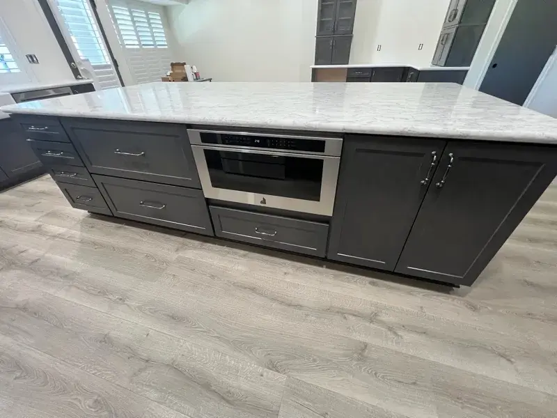 Kitchen project by Barron's Flooring & Home in Ione, CA featuring Kemper Maple cabinets, Marimac door, Colt stain, MSI Calacatta Ocellio 2cm quartz, MSI Calacatta Izaro 2cm quartz