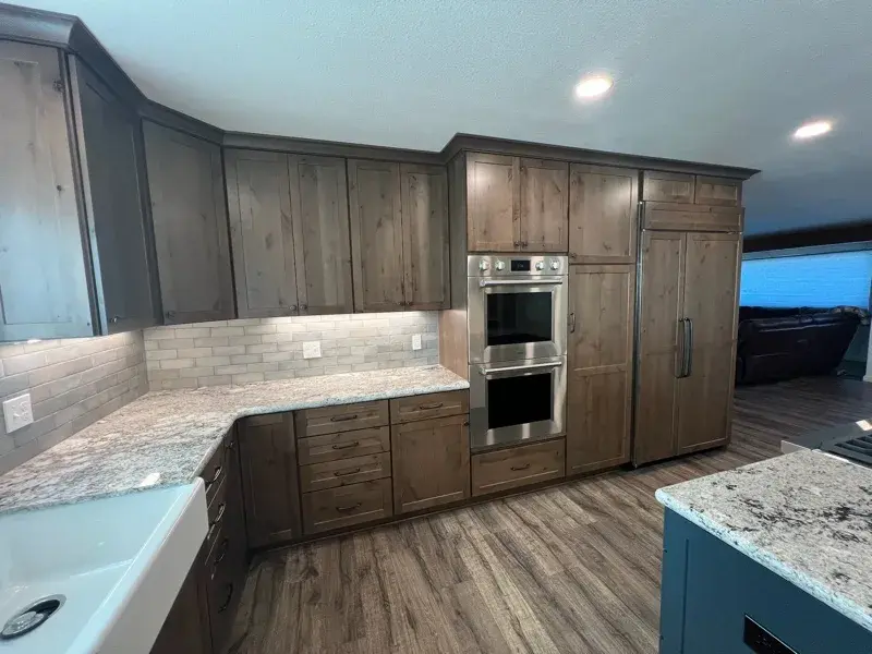 Kitchen project by Barron's Flooring & Home in Plymouth, CA featuring Kemper Rustic alder cabinets, Marric door, Morel stain, Kemper Maple cabinets, Marric door, painted Maritime, MSI Avalon White 2cm granite