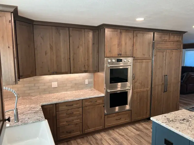 Kitchen project by Barron's Flooring & Home in Plymouth, CA featuring Kemper Rustic alder cabinets, Marric door, Morel stain, Kemper Maple cabinets, Marric door, painted Maritime, MSI Avalon White 2cm granite