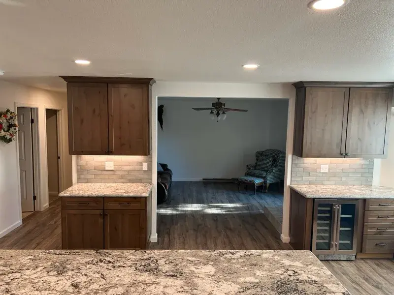 Kitchen project by Barron's Flooring & Home in Plymouth, CA featuring Kemper Rustic alder cabinets, Marric door, Morel stain, Kemper Maple cabinets, Marric door, painted Maritime, MSI Avalon White 2cm granite