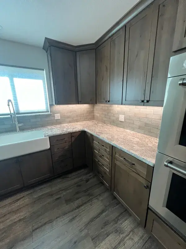 Kitchen project by Barron's Flooring & Home in Plymouth, CA featuring Kemper Rustic alder cabinets, Marric door, Morel stain, Kemper Maple cabinets, Marric door, painted Maritime, MSI Avalon White 2cm granite