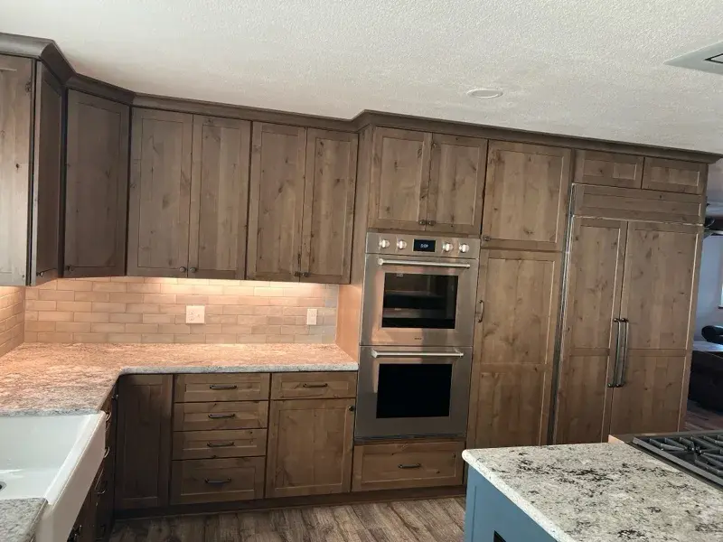 Kitchen project by Barron's Flooring & Home in Plymouth, CA featuring Kemper Rustic alder cabinets, Marric door, Morel stain, Kemper Maple cabinets, Marric door, painted Maritime, MSI Avalon White 2cm granite