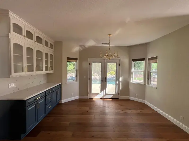 Kitchen project by Barron's Flooring & Home in Loomis, CA featuring Canyon Creek Maple cabinets painted Snow Cap, Canyon Creek Maple cabinets painted Breeze, Cambria Berkshire Brass Satin Ridge 2cm quartz