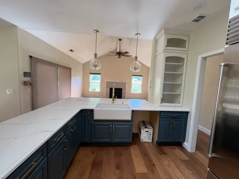 Kitchen project by Barron's Flooring & Home in Loomis, CA featuring Canyon Creek Maple cabinets painted Snow Cap, Canyon Creek Maple cabinets painted Breeze, Cambria Berkshire Brass Satin Ridge 2cm quartz