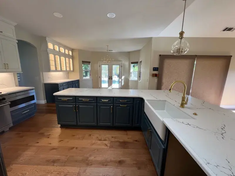 Kitchen project by Barron's Flooring & Home in Loomis, CA featuring Canyon Creek Maple cabinets painted Snow Cap, Canyon Creek Maple cabinets painted Breeze, Cambria Berkshire Brass Satin Ridge 2cm quartz