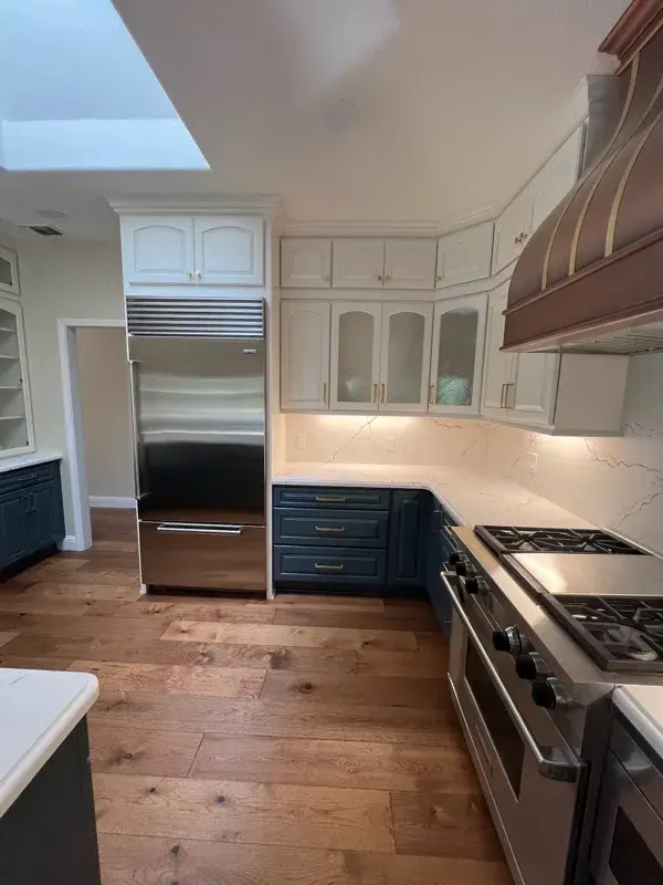 Kitchen project by Barron's Flooring & Home in Loomis, CA featuring Canyon Creek Maple cabinets painted Snow Cap, Canyon Creek Maple cabinets painted Breeze, Cambria Berkshire Brass Satin Ridge 2cm quartz