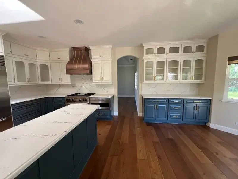 Kitchen project by Barron's Flooring & Home in Loomis, CA featuring Canyon Creek Maple cabinets painted Snow Cap, Canyon Creek Maple cabinets painted Breeze, Cambria Berkshire Brass Satin Ridge 2cm quartz