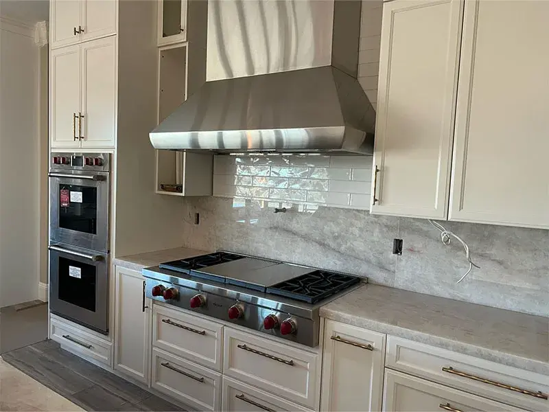 Kitchen project by Barron's Flooring & Home in Jackson, CA featuring Canyon Creek Maple painted cabinets, Quartzite countertop, Surface Art Subway tile