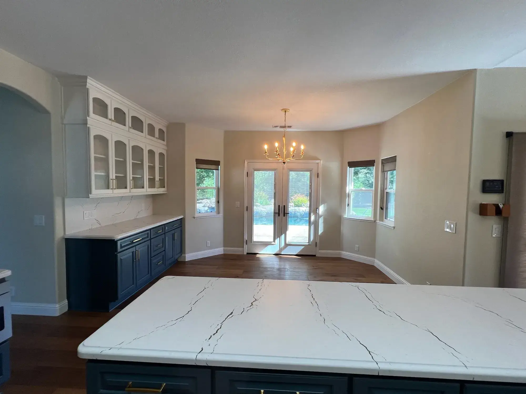 Kitchen with a white quartz waterfall island installed by Barron's