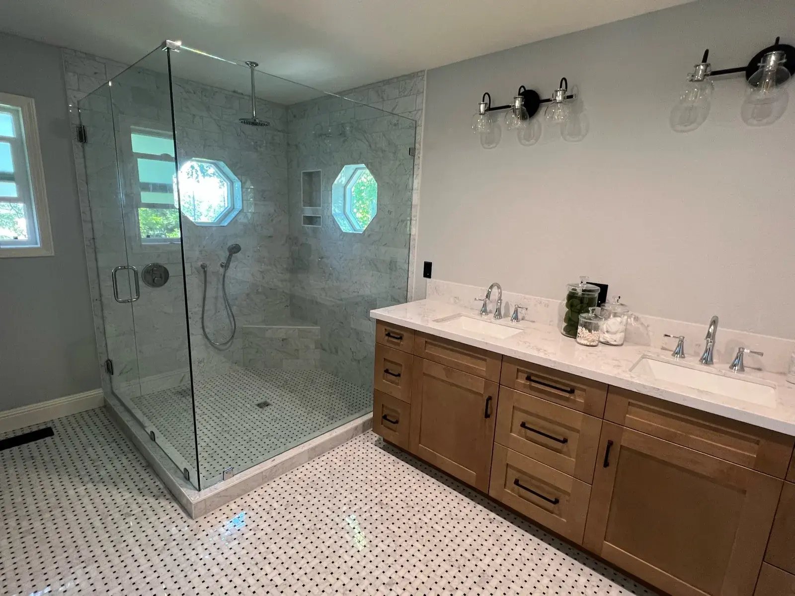 Master bathroom with a frameless glass walk-in shower and a wood double vanity