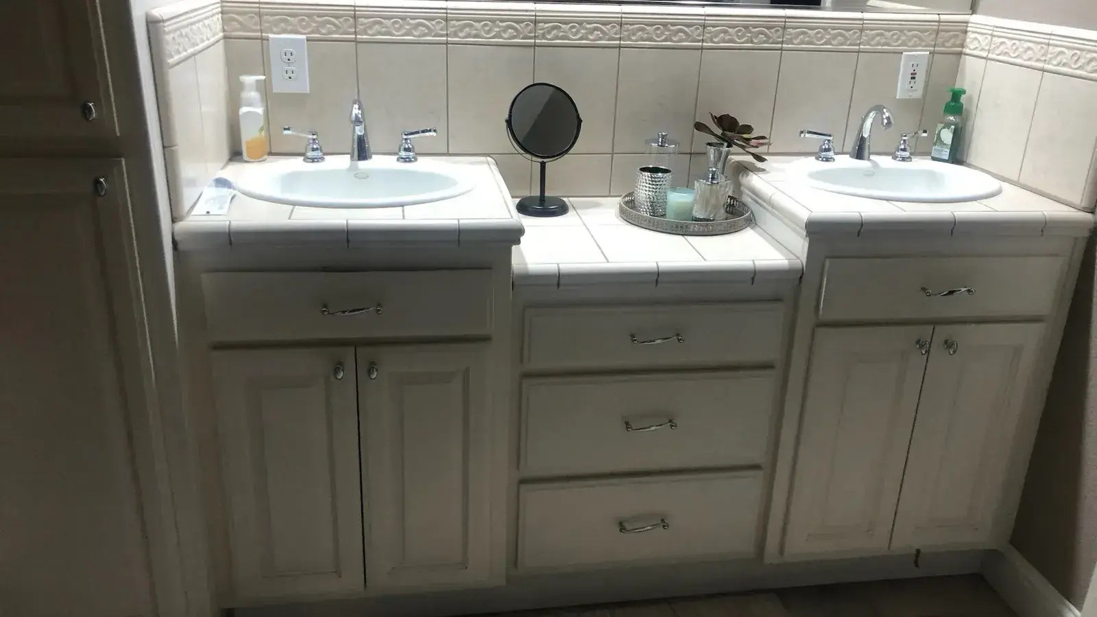 Before: Dated double vanity with cultured-marble sinks before remodel
