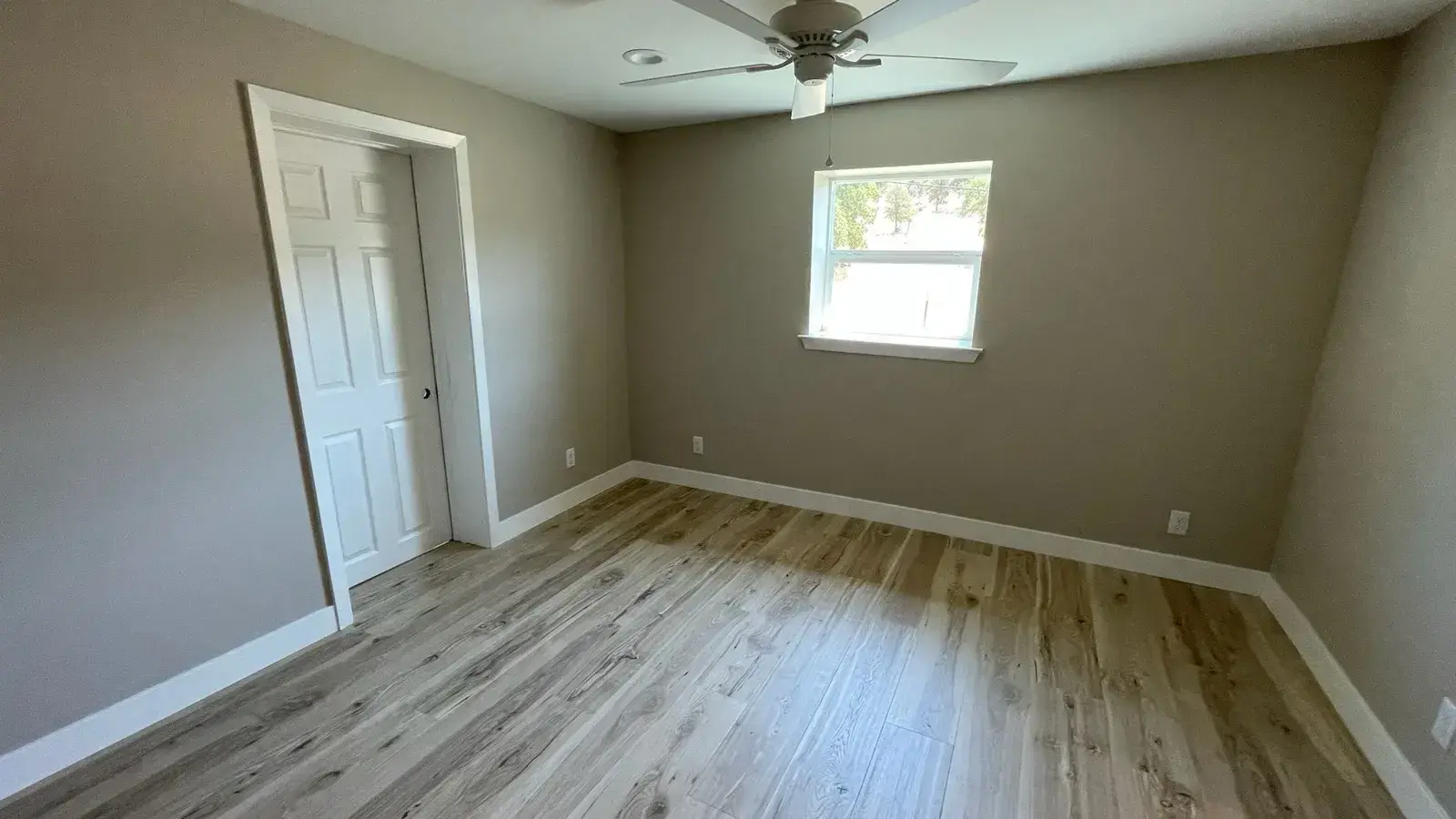 After: Bedroom finished with new wood flooring