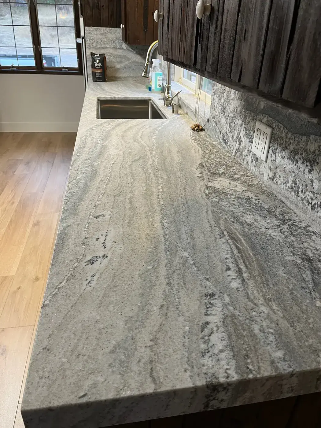 Leathered-finish granite countertop with a full backsplash and undermount sink
